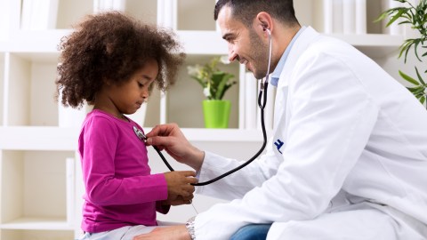 A doctor diagnosing a young girl with anxiety