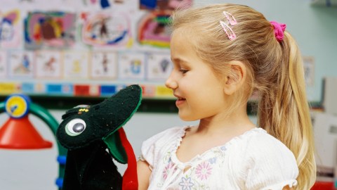A girl talking to a puppet, a good tool to manage anxiety in young children