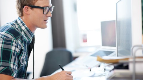 A software developer with ADHD works at his computer on stimulating tasks that captivate this attention for a few weeks at a time.