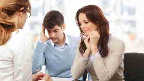 Young couple discussing ADHD with a doctor