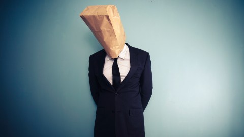 An adult with ADHD has a bag over his head, symbolizing the shame that often accompanies ADHD.