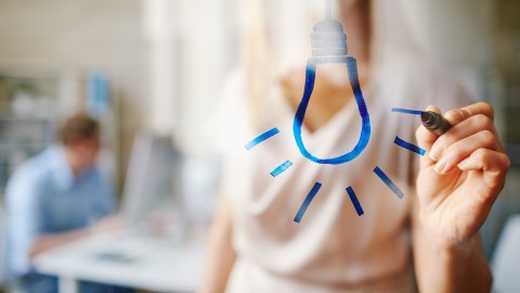 Woman with ADHD drawing a lightbulb because People with ADHD nervous systems are usually much brighter and more creative than the average neurotypical person