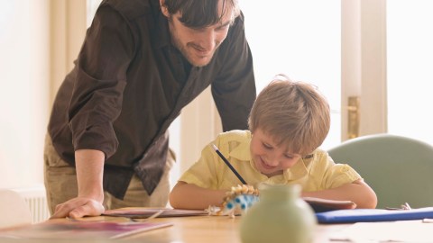 A father working on homework with this ADHD son.