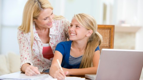 A parent and her daughter work on homework together, helping to relieve homework stress and frustration.