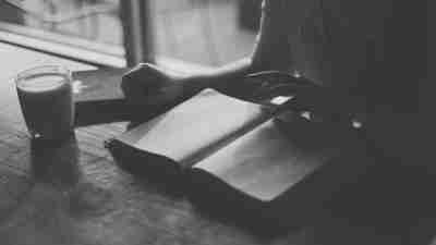 Black and white image of someone reading a book with fictional characters who have ADHD