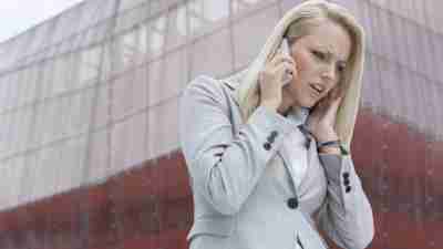 Woman with ADHD having trouble hearing someone on cell phone