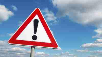 Triangular street sign with exclamation point in it and sky above symobolizing the potential toxic risk factors and their effects on ADHD diagnosis