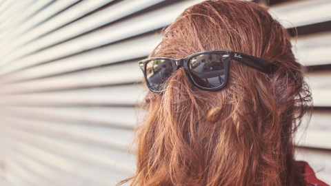 A girl with ADHD with her hair over her face after someone told her ADHD is not real